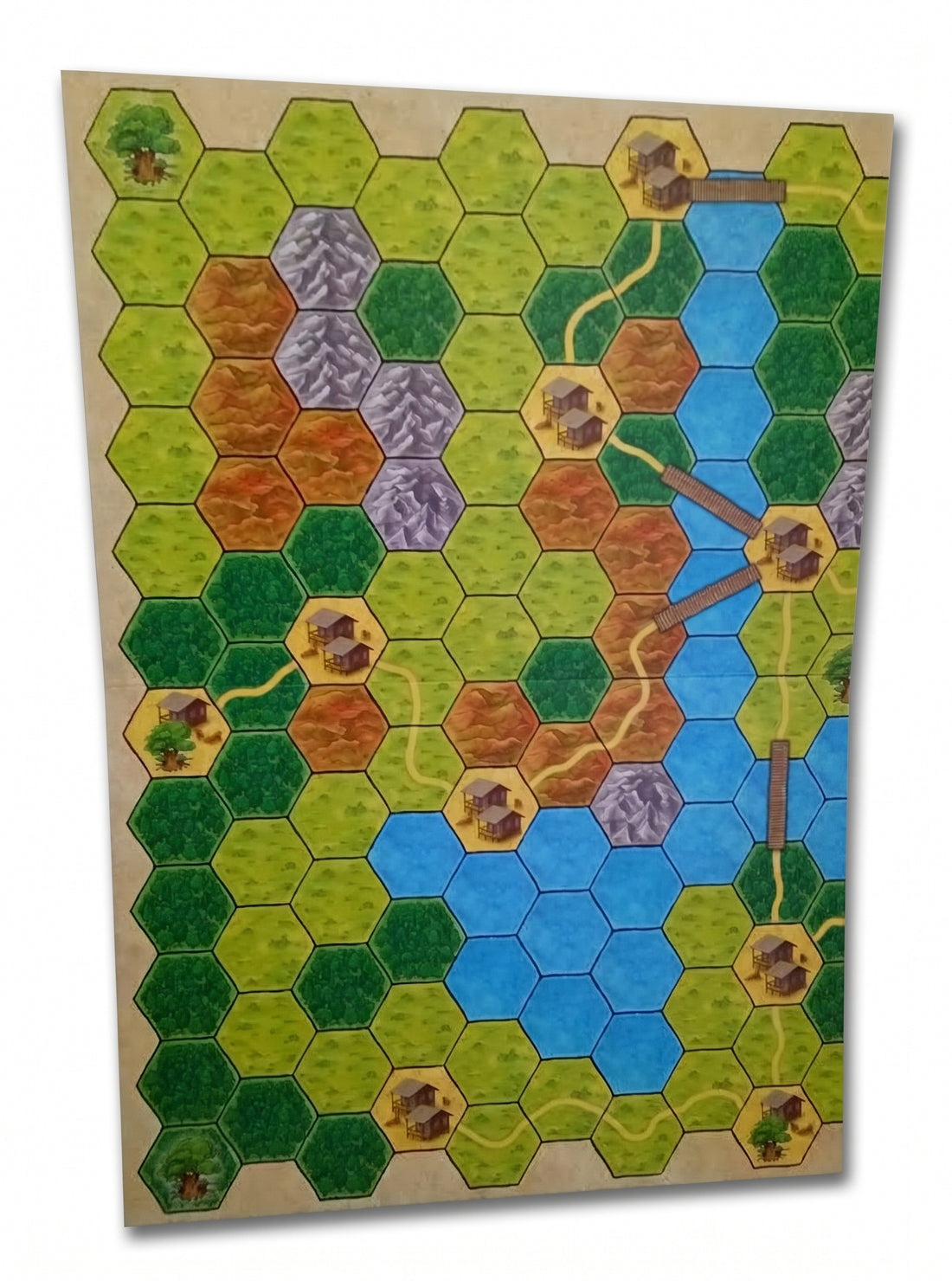 double-sided game board with hexagonal landscapes